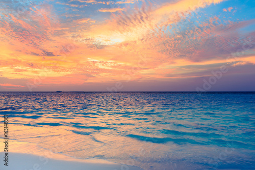 Maldives. Colorful sunset over the Indian Ocean. Fantastic clouds in the sky after sunset.