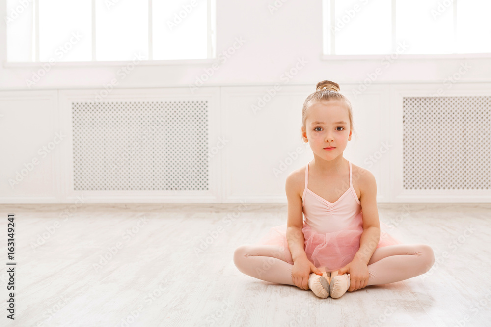 Portrait of little ballerina on floor, copy space Portrait of little ballerina on floor, copy space