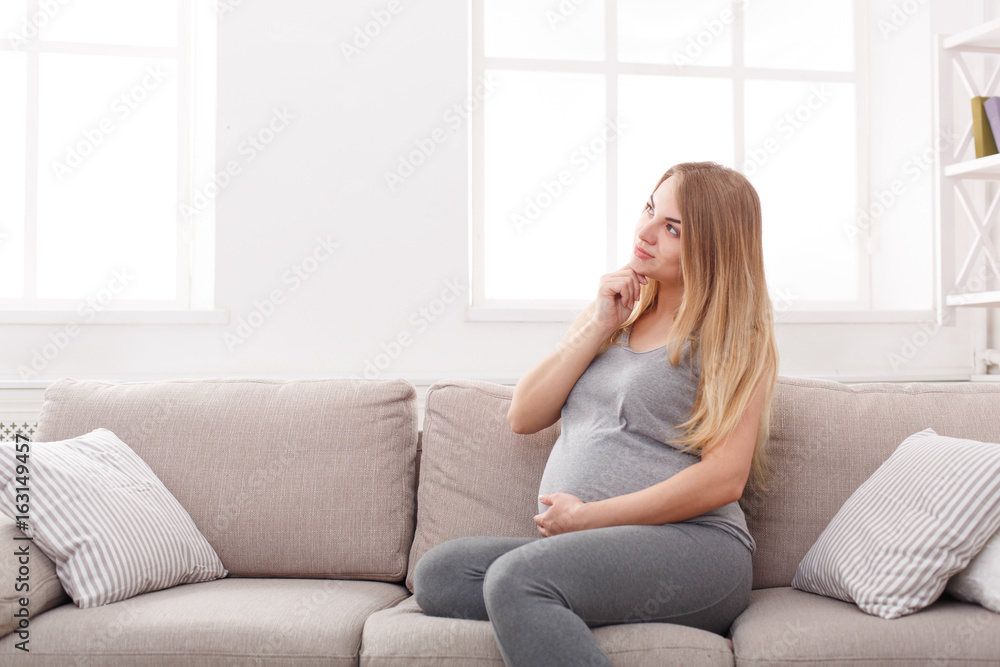 Pensive pregnant woman dreaming about child Pensive pregnant woman dreaming about child