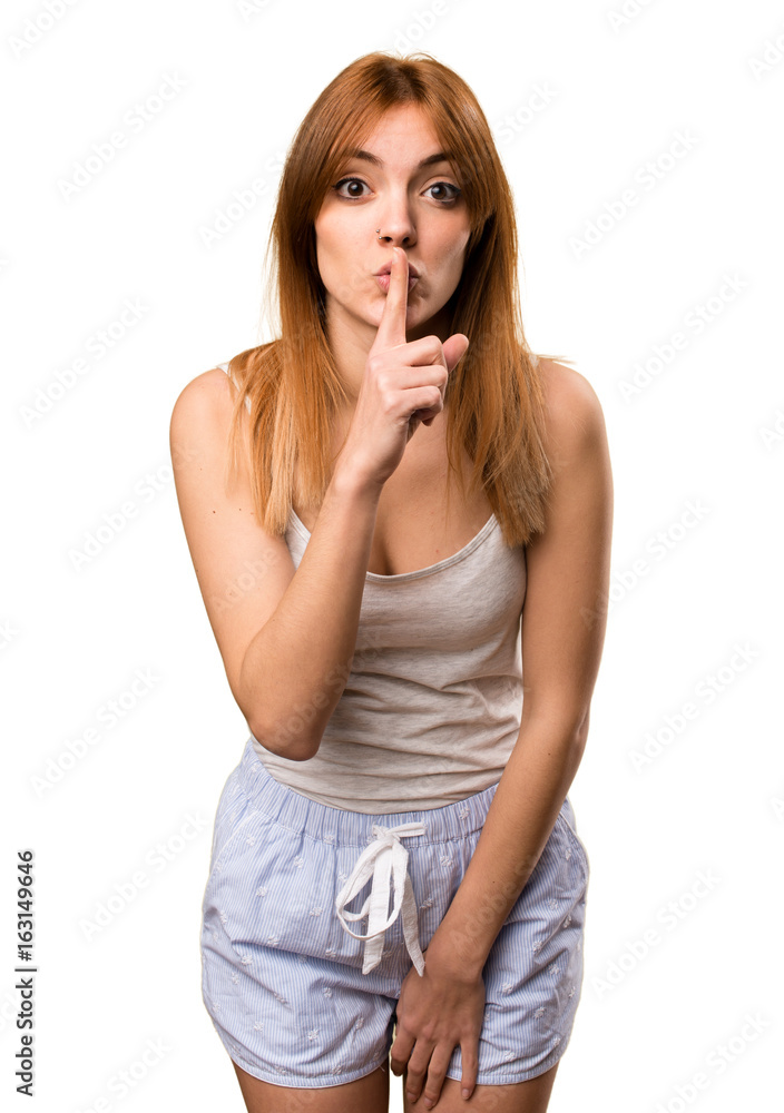 Beautiful girl in pajamas making silence gesture Beautiful girl in pajamas making silence gesture