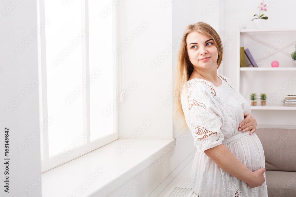 Pensive pregnant woman dreaming about child Pensive pregnant woman dreaming about child