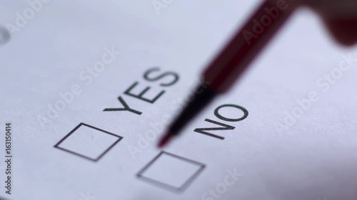 Cropped of businessman writing on checklist photo