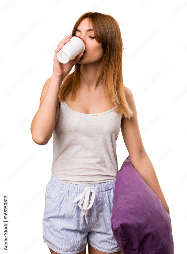 Beautiful girl in pajamas holding a cup of coffee Beautiful girl in pajamas holding a cup of coffee