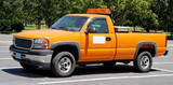 Orange department of transportation utility pickup truck.
