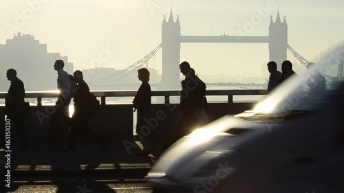 UK, England, London, Commuters crossing London Bridge, Tower Bridge beyond photo