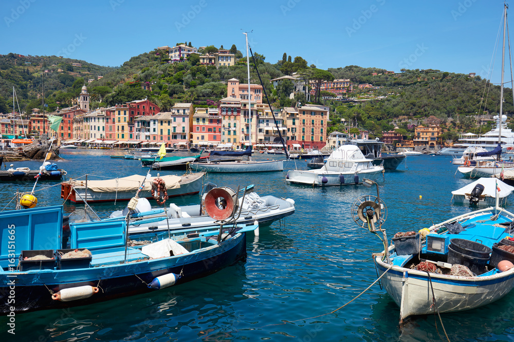 Portofino typical beautiful village with colorful houses in Italy, fishing boats