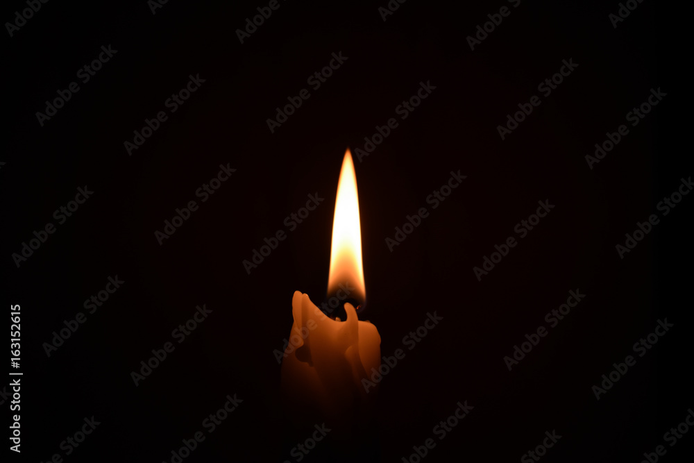Candle on the dark background isolated Candle on the dark background isolated