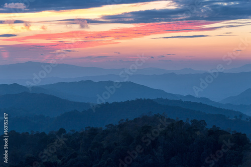 Layer of mountains in the mist at sunset time with burning sky, Nan Province, Thailand © narathip12