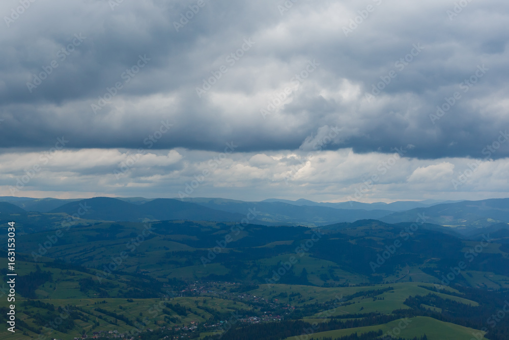 Summer landscape in mountains and the dark blue sky with clouds. storm