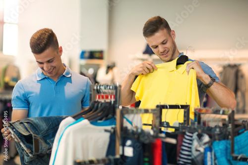 Two men deciding on new sportswear in sports store