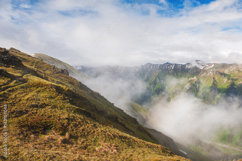 Beautiful mountain landscape in fog and blue sky Beautiful mountain landscape in fog and blue sky
