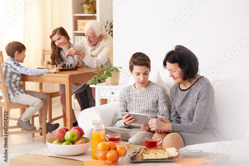 Boy and grandmother using tablet