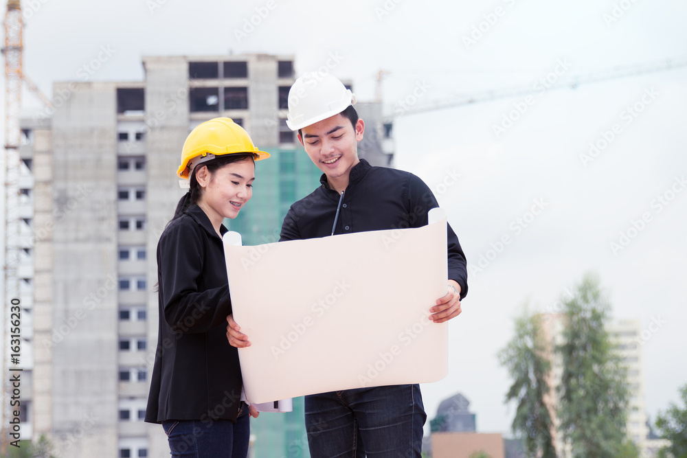 Engineer contractor reading drawing building with under construction building background. Engineer contractor reading drawing building with under construction building background.