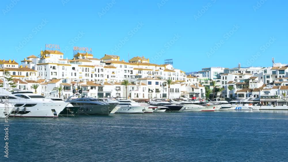UHD 4k Puerto Banus near Marbella, Spain. Slow pan left to right of the harbour in Puerto Banus Spain showing the super yachts and motor cruisers of the rich and famous. UHD 4k Puerto Banus near Marbella, Spain. Slow pan left to right of the harbour in Puerto Banus Spain showing the super yachts and motor cruisers of the rich and famous.