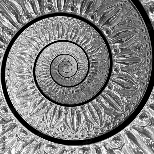 Silver metal abstract spiral fractal pattern on black background. Lattin floral pattern. Metallic paper spiral background. Traditional silver ornament pattern background. Spiral effect pattern photo