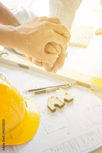 Estate agent shaking hands with customer after contract signature buy home.