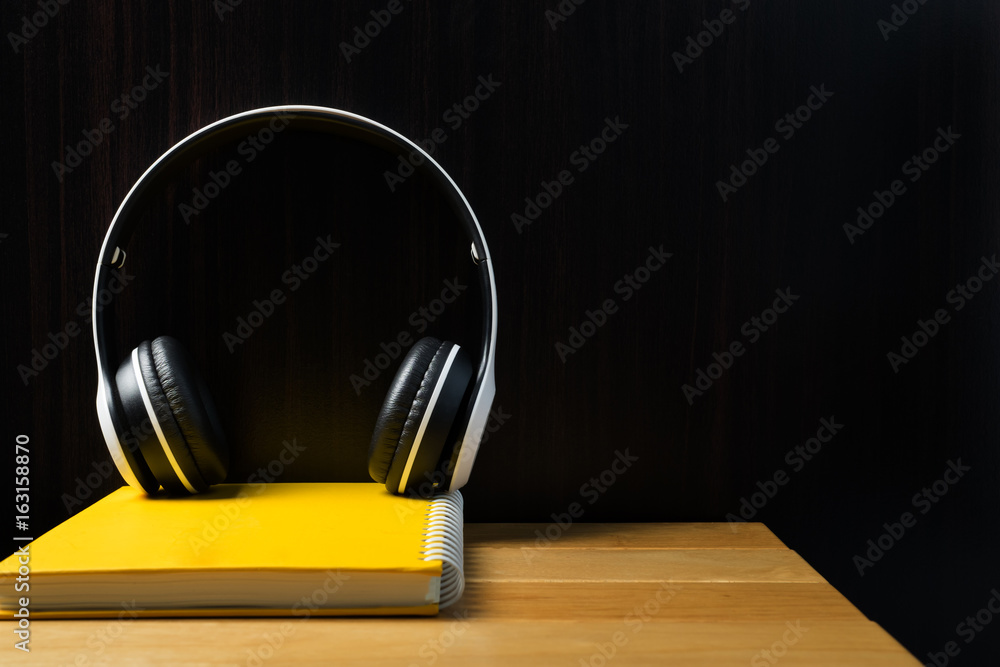 headphones yellow notebook on the table.