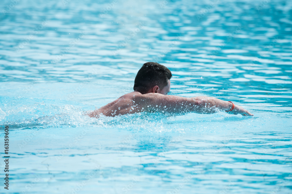 Man swimmer athlete swimming in pool StockFoto Adobe Stock