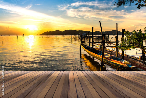 wooden floor and hanging boat at the lake in background space for your text or object in photo.