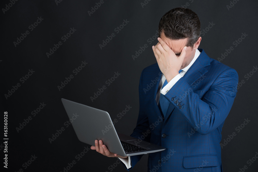 Man or manager hiding face with hand in blue suit Man or manager hiding face with hand in blue suit