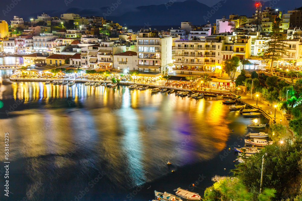 Naklejka premium Agios Nikolaos, one of the most touristic cities on Crete island, at summer evening, Greece.
