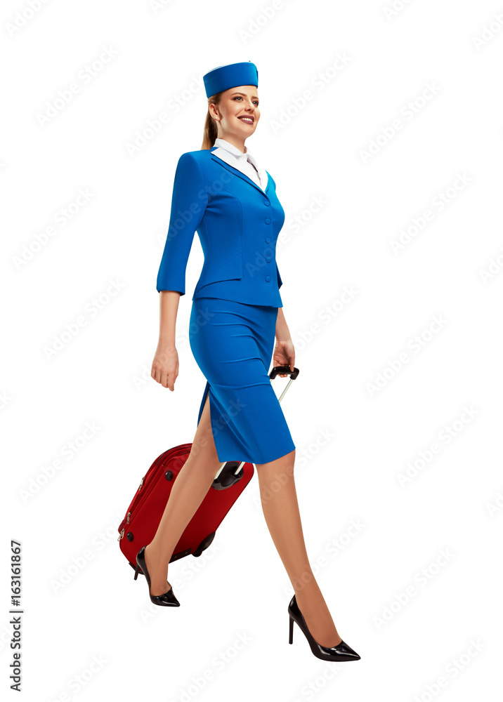 The stewardess goes and rolls her suitcase.