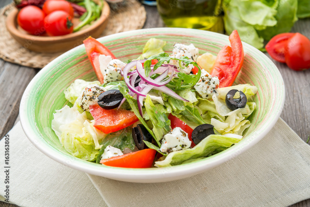 Greek salad with fresh vegetables, feta cheese and black olives Greek salad with fresh vegetables, feta cheese and black olives