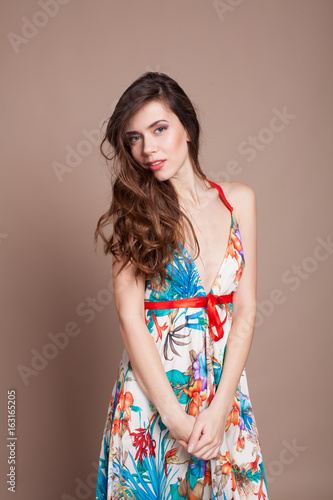 Beautiful girl in colored dress posing smile