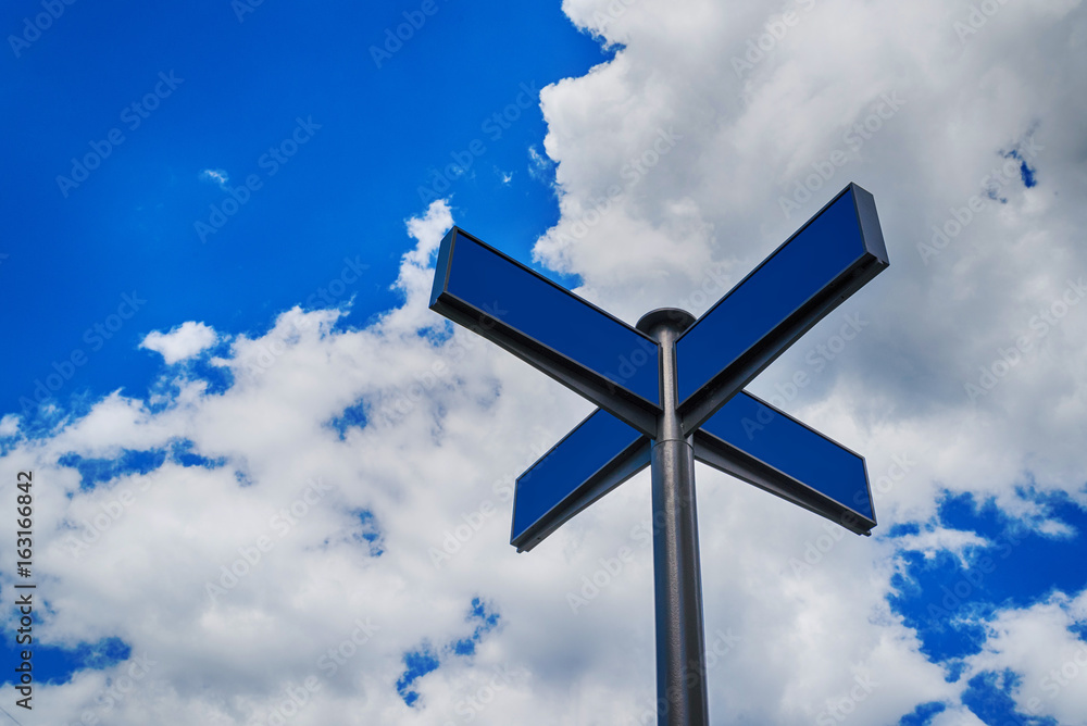 Blank blue traffic road signs in bright sky with clouds, free space for text. Blank street sign on cloudy sky background, copy space Blank blue traffic road signs in bright sky with clouds, free space for text. Blank street sign on cloudy sky background, copy space