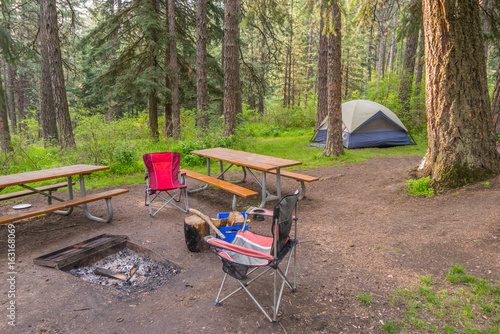 Grey tent and chairs on a background of the green forest.  Kamiak Butte State Park Campground,  Whitman County, Washington, USA   photo