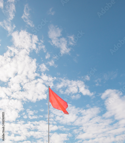 red flag flying in the blue sky