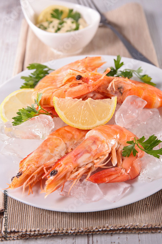 boiled shrimp with ice cube and lemon