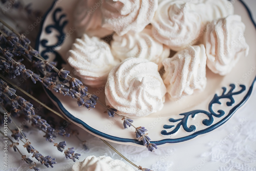 White marshmallow with dried lavender on a plate with a blue pattern