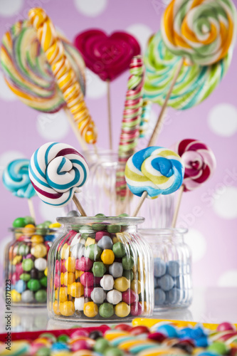 Different colorful sweets and lollipops and gum balls