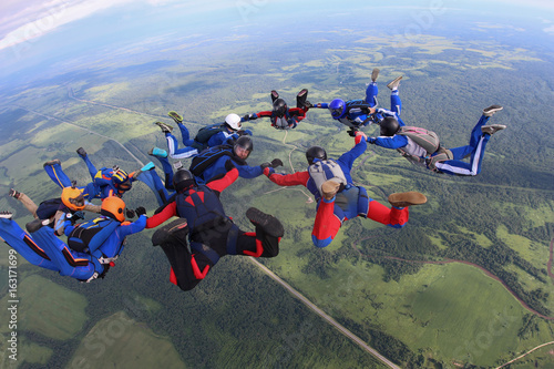The team of skydivers is in the sky