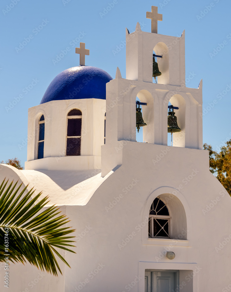 Typical white church and bell tower in Santorini, Greece