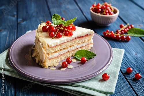 Delicious cake with mascarpone, whipped cream, red currant and almond slices