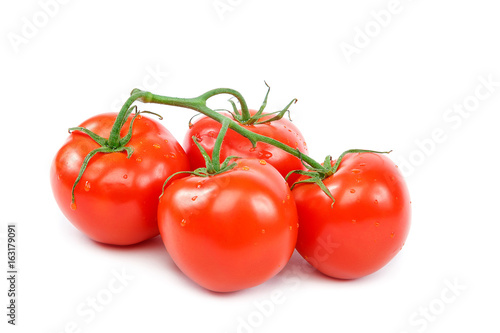 Branch of a fresh red tomato on a white background.