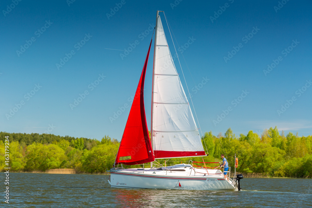 Yacht with red and white sail Sunny day Yacht with red and white sail Sunny day