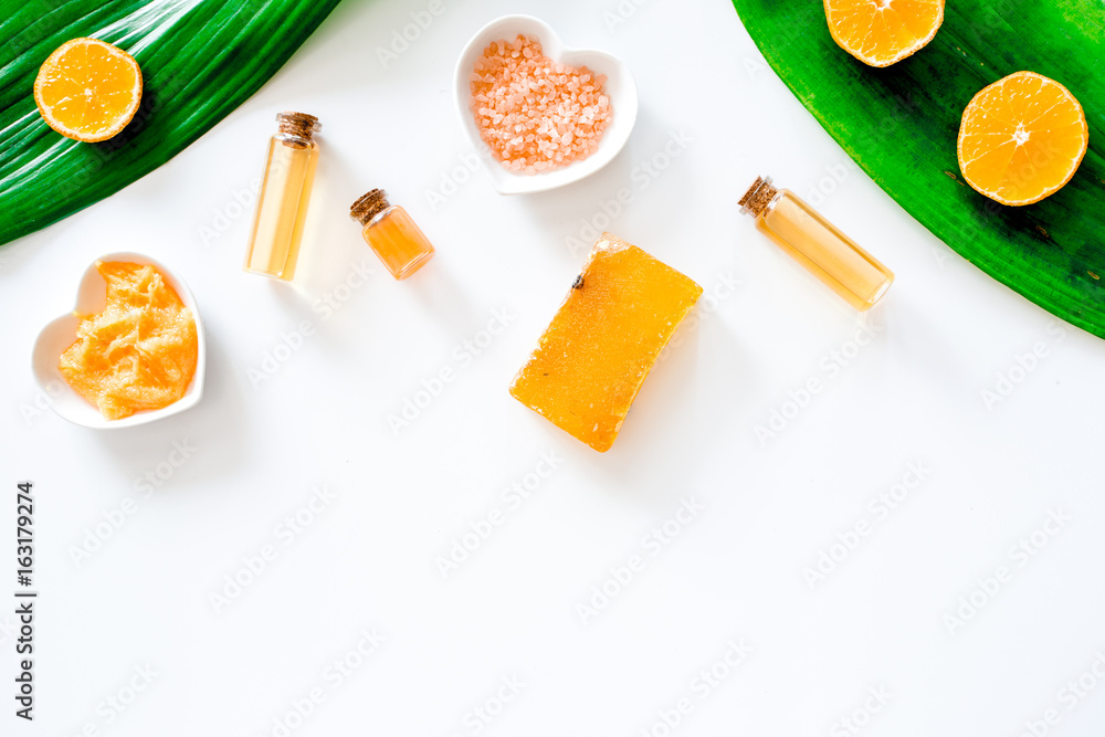Aroma spa set. Citrus scrub, soap, salt and lotion on white background top view copyspace Aroma spa set. Citrus scrub, soap, salt and lotion on white background top view copyspace
