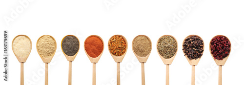 Collage of different seasoning in wooden spoon