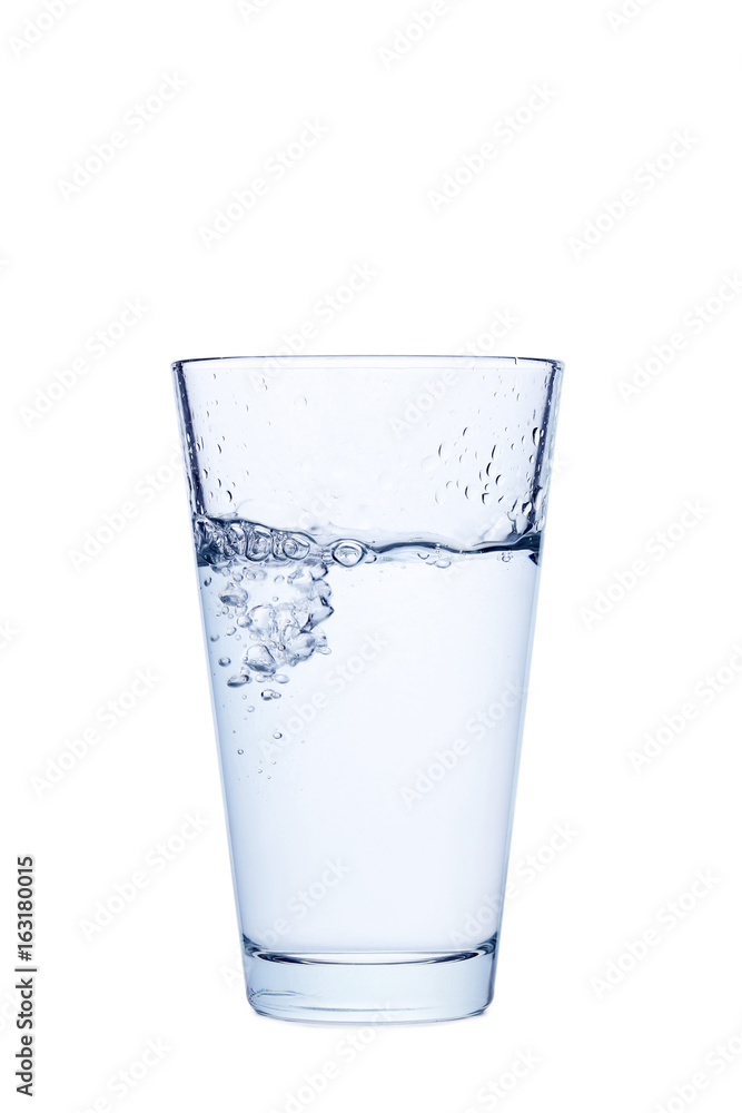 Water pouring in glass isolated on a white Water pouring in glass isolated on a white