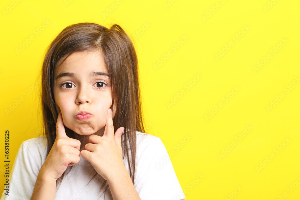 Beautiful little girl on yellow background Beautiful little girl on yellow background