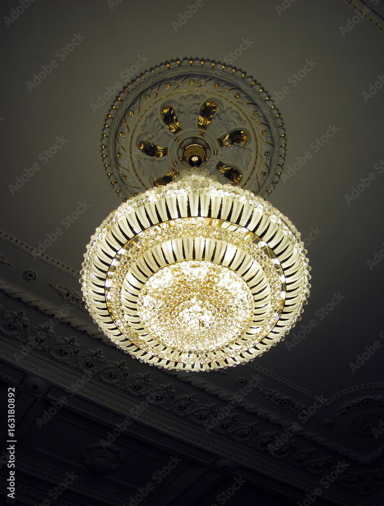 Fototapeta premium Beautiful chandelier weighs on the ceiling
