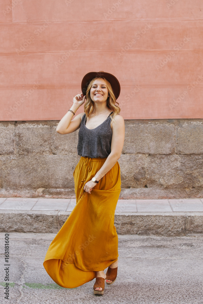 cheerful blonde woman with hat walking on the street cheerful blonde woman with hat walking on the street
