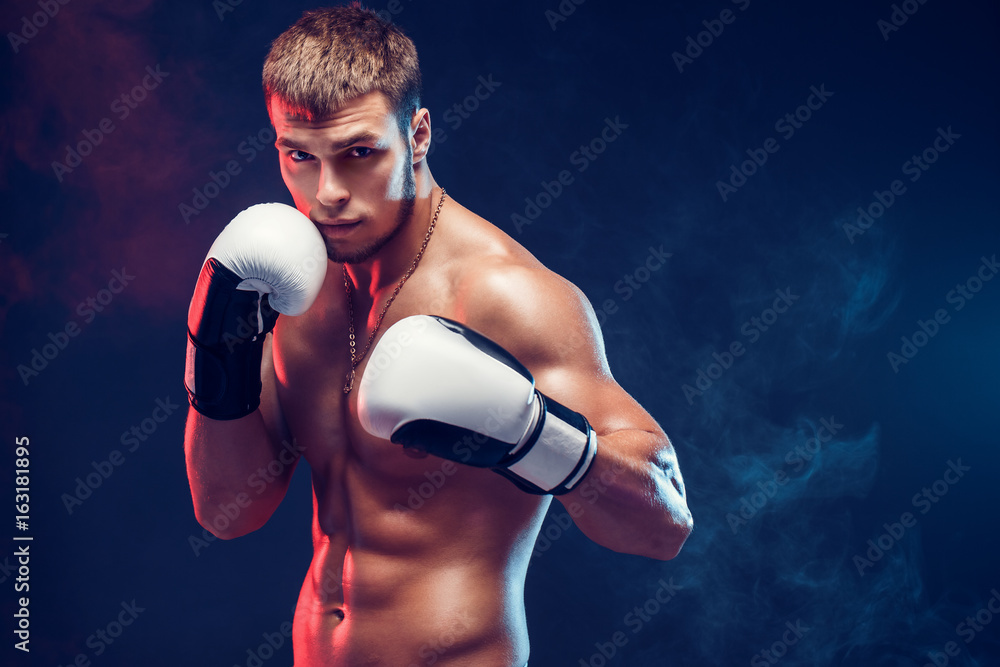 Aggressive shirtless boxer on dark smoke background. - obrazy, fototapety, plakaty 