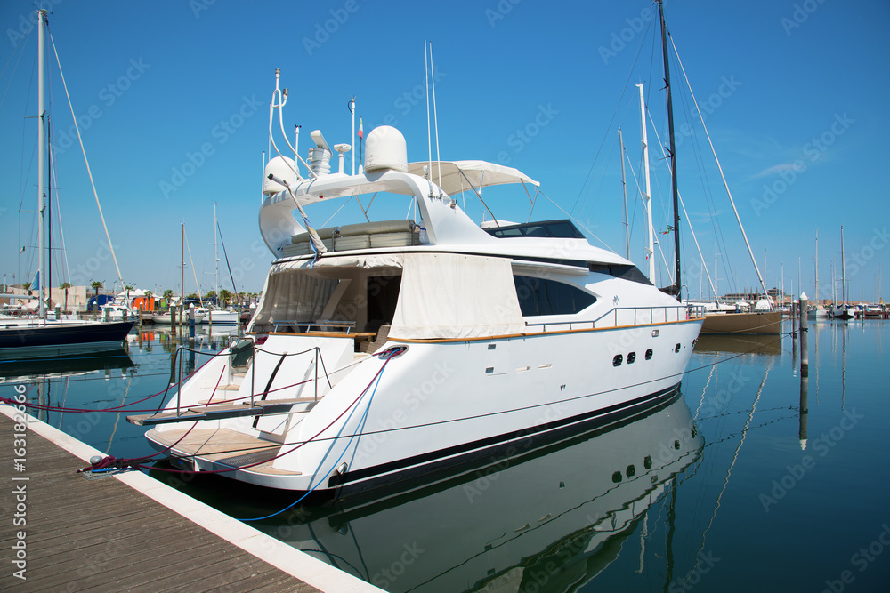 White yacht in the port waiting. On the sea is calm. White yacht in the port waiting. On the sea is calm.
