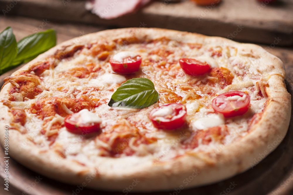 rustic italian pizza with mozzarella, cheese and basil leaves rustic italian pizza with mozzarella, cheese and basil leaves