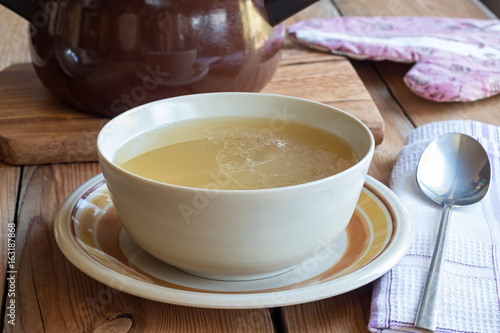 Bone broth made from chicken served in a soup bowl