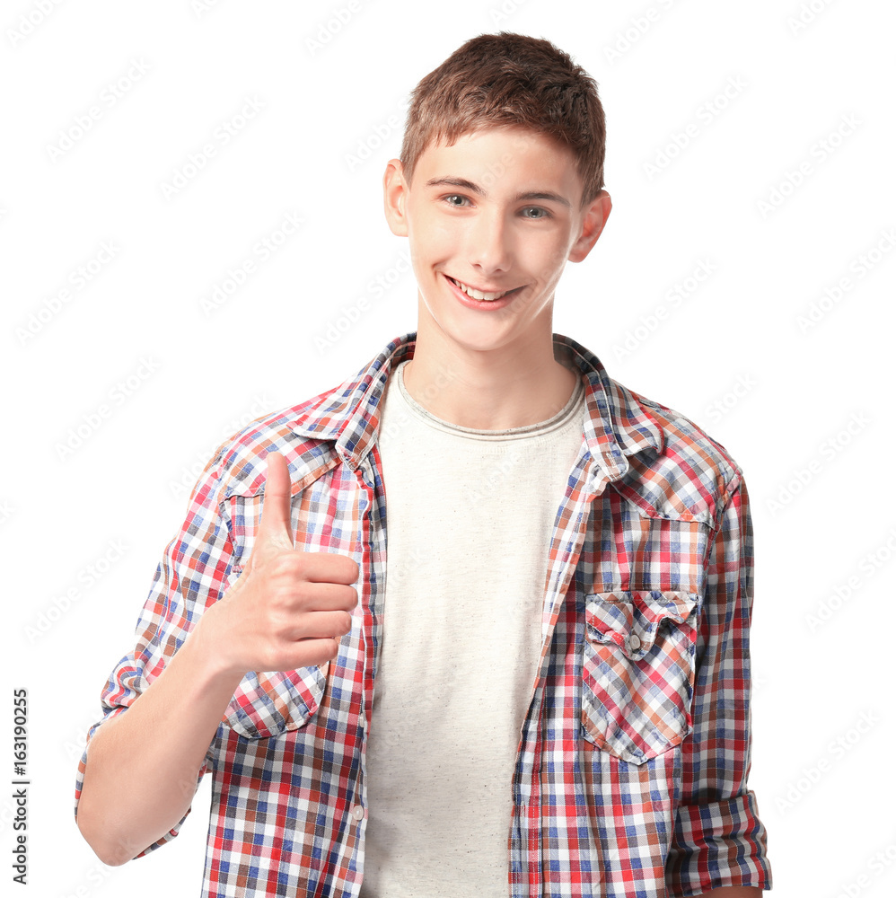 Happy smiling teenager showing thumb up sign on white background Happy smiling teenager showing thumb up sign on white background